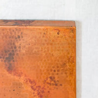 light patina of Hammered copper rectangular table top with a rich, textured surface and a warm, metallic sheen