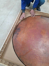 Close-up view of the unique hand-hammered texture on a premium copper table top, highlighting artisanal detail