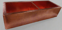 Side view of the double-bowl hammered copper kitchen sink with apron, emphasizing its sturdy construction and sleek design.