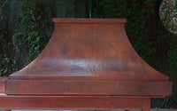 Front view of the hammered copper range hood FARMHOUSE with vintage patina, displaying its rustic and elegant design.