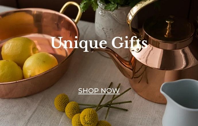 An assortment of unique copper gifts, featuring a variety of beautifully crafted items such as intricately designed copper mugs, elegant decorative pieces, and artisanal kitchenware. Each piece showcases the rich, warm tones and distinctive hammered textures of high-quality copper, making them perfect for adding a touch of luxury and elegance to any home or special occasion.