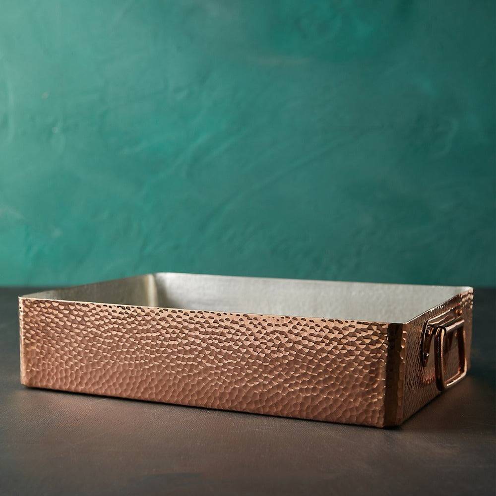 Built to the Amoretti Brothers standard, this trusty roasting pan is set to be your favorite copper cookware.  Made from hand-hammered copper, our spacious roasting pan provides you with 13.7” x 9.8” of cooking area. Double layer tin interior lining covers the entire inner space of the roasting pan. Applied by hand by our copper smiths, this protective covering ensures your roasting pan withstands even the most constant use.