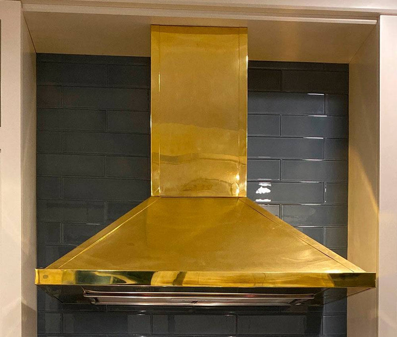 Francesca brass range hood, showcasing its elegant design and polished brass finish.