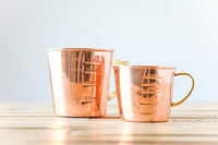 Copper liquid measuring cup with interior and exterior markings; Brass handle; 4 Cup Capacity. Add the 2.5 cup measuring cup to make it a set. Functional as well as beautiful.