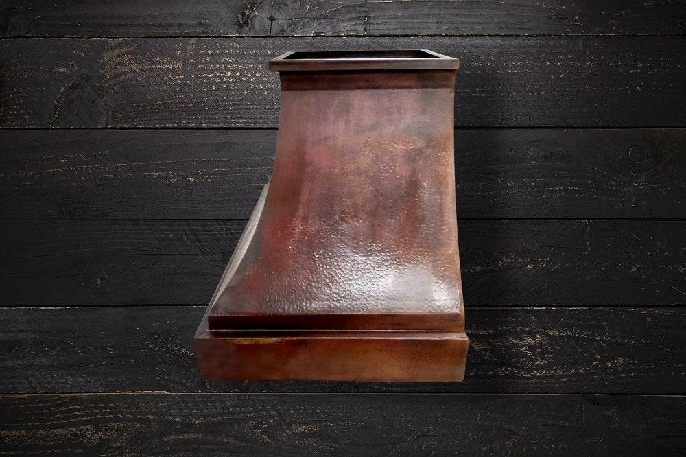 Side view of the hammered copper range hood FARMHOUSE with vintage patina, emphasizing its durable construction and rustic design.