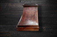 Side view of the hammered copper range hood FARMHOUSE with vintage patina, emphasizing its durable construction and rustic design.