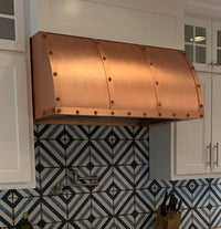 Side view of the Winston copper range hood with barrel shape, emphasizing its durable construction and sleek design.