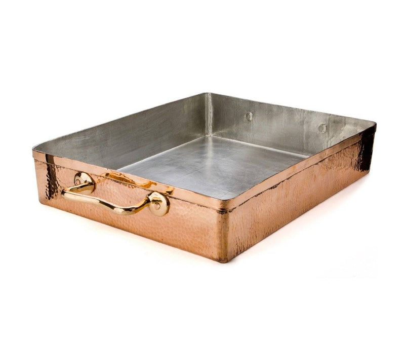 Create an appetizing platter with this elegant serving board.  Entirely handcrafted, this rectangular serving board is made of bleached wood. This subtle backdrop makes for a high contrast that highlights your meats, cheeses, and fruits. Delicate copper edge is riveted into place and frames the rest of the board, providing a touch of luxury to this minimal piece. Leaf engravings extend throughout the copper border, adding another layer of understated refinement.