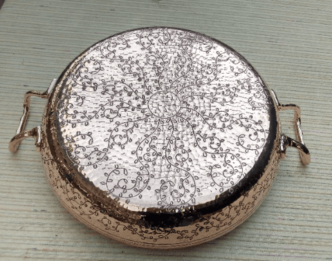 Hand-engraved copper paella pan with dual handles, 13-inch size, crafted from recycled copper and tin-lined for superior heat distribution.