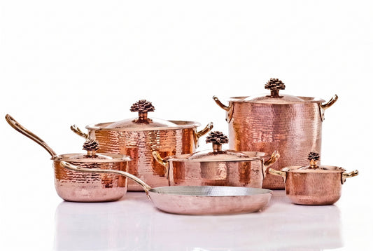 Set of copper cookware by Amoretti Brothers on a white background