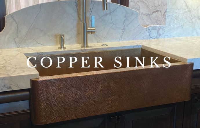 A beautiful copper farmhouse sink with a rich, warm patina, showcasing its handcrafted design. The sink's spacious, deep basin and apron front add a touch of rustic elegance to the kitchen, combining functionality with timeless style. The hammered texture of the copper surface highlights the artisanal craftsmanship, making it a standout feature in any kitchen decor.