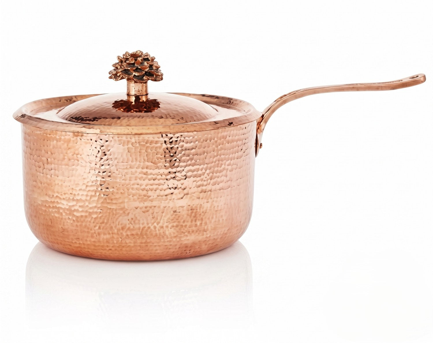 Hammered copper saucepan with lid on a white background