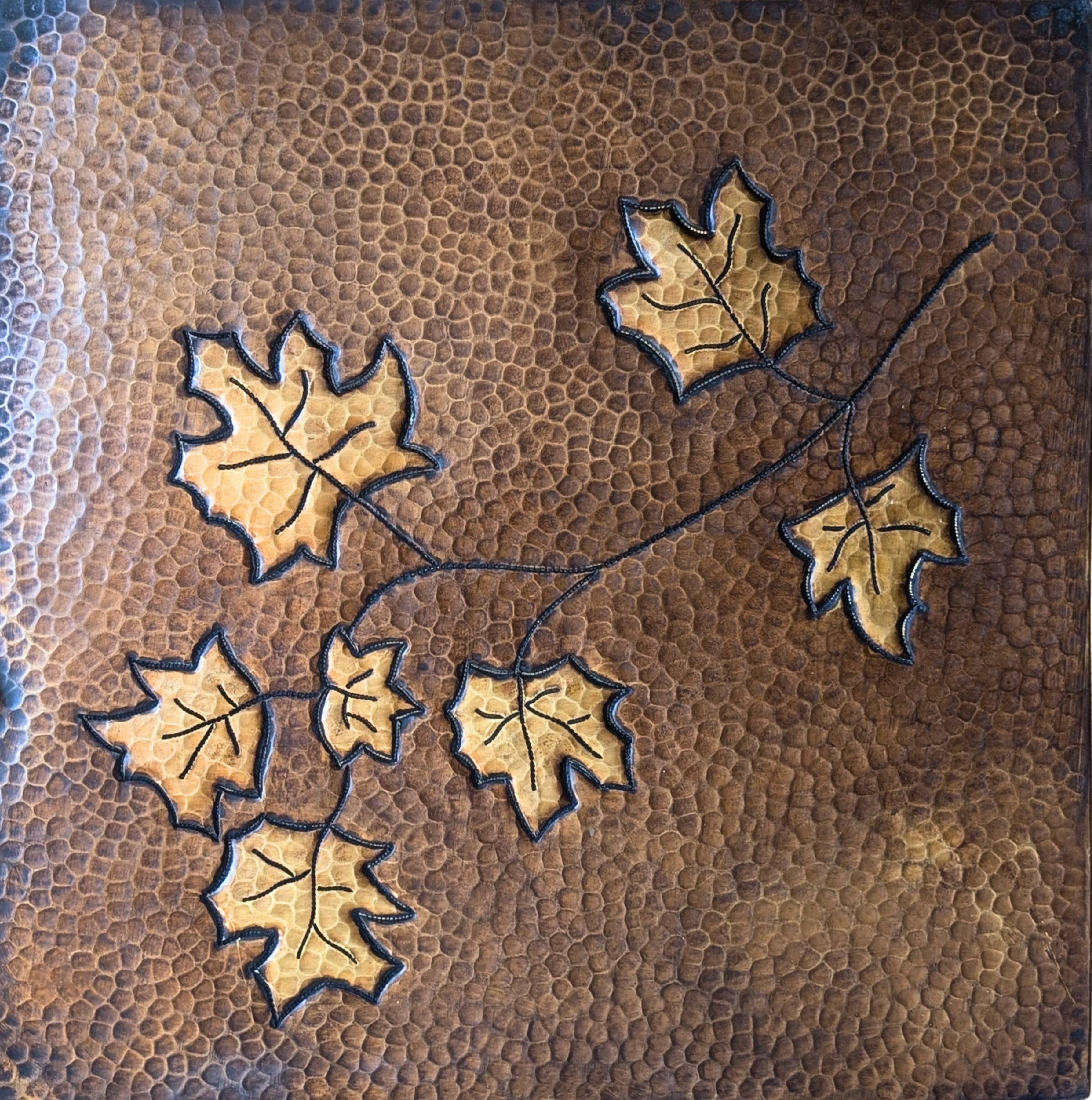 Artisan copper backsplash panel with leaf motif and rich brown patina