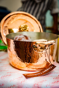Amoretti Brothers Copper dutch oven with a lid on a table