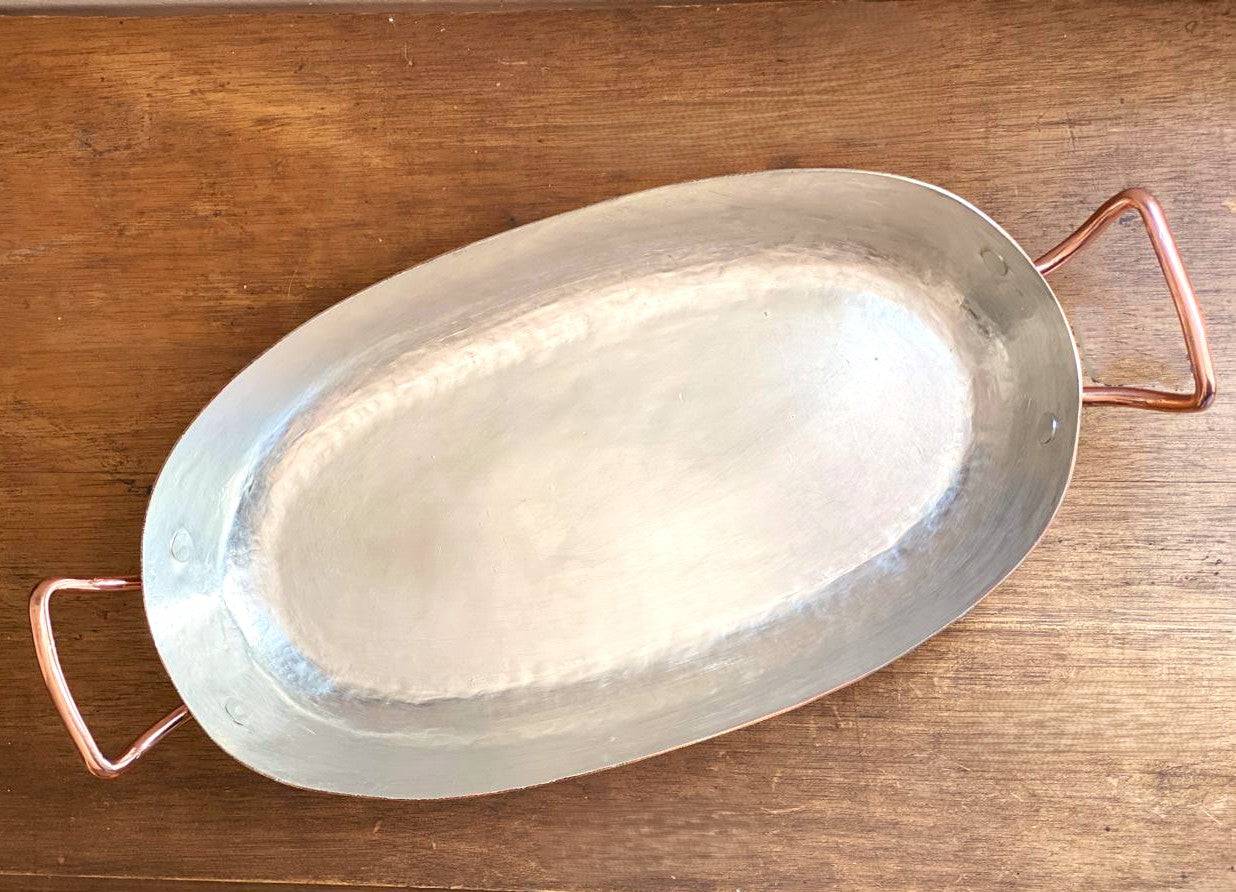 Top view of 13.5" oval copper pan showing interior tin surface