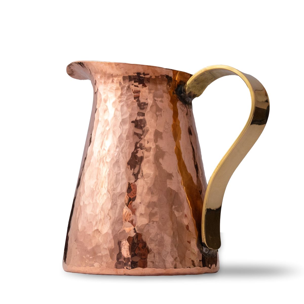 Close-up of hammered copper jug with solid brass handle