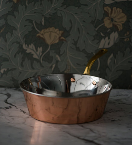 Handmade copper Windsor warming pan with brass handle, showing stainless steel-lined interior and elegant design