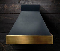 Black and brass range hood with vintage patina by Amoretti Brothers SARA