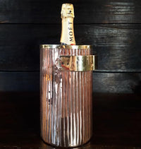 copper ice bucket with moet bottle of champagne by Amoretti Brothers