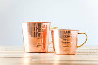 Copper liquid measuring cup with interior and exterior markings; Brass handle; 4 Cup Capacity. Add the 2.5 cup measuring cup to make it a set. Functional as well as beautiful.